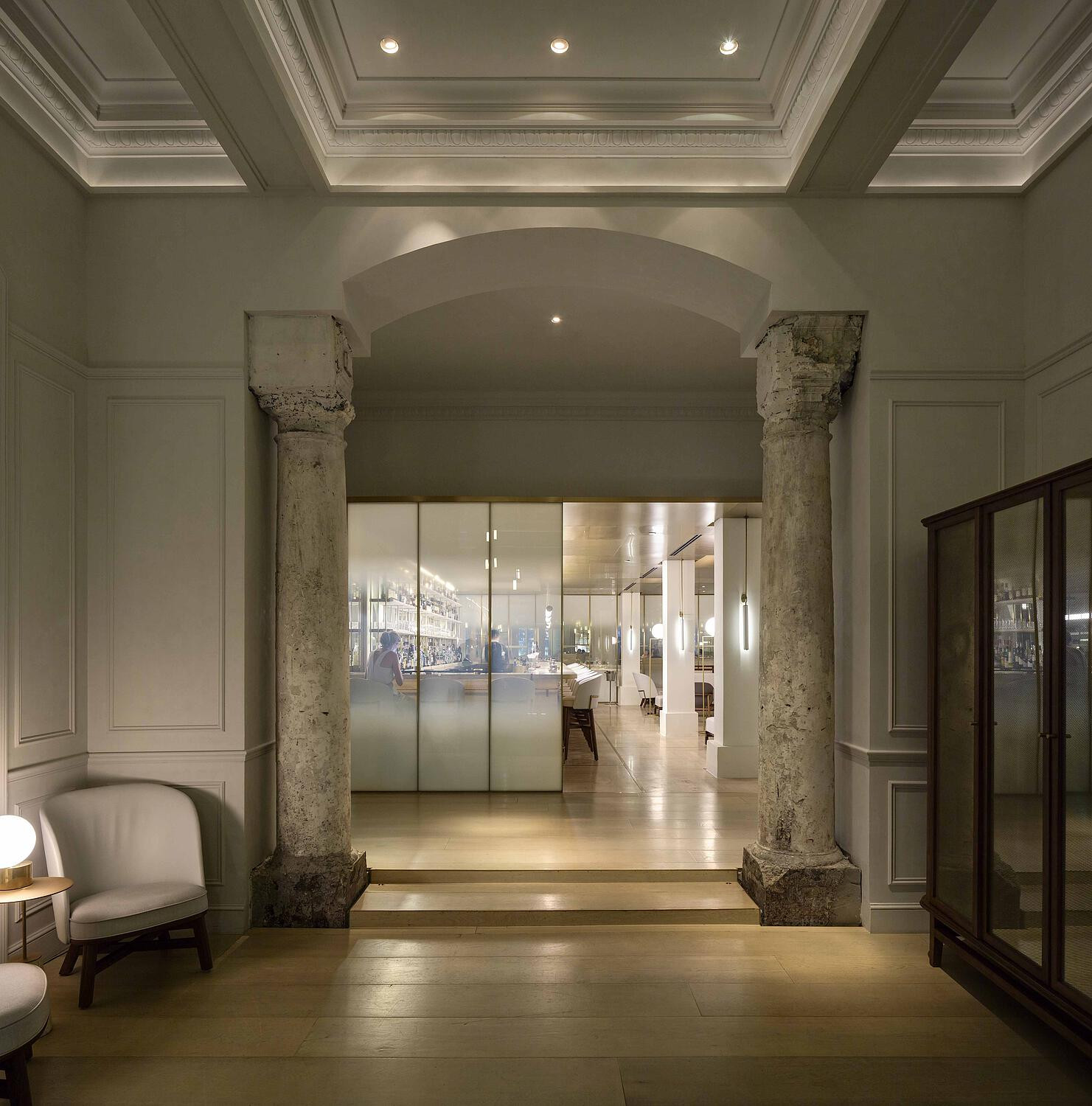 The reception foyer of Jean-Georges, with the original classical columns exposed during Neri&Hu’s 2016 renovation after decades beneath accumulated finishes