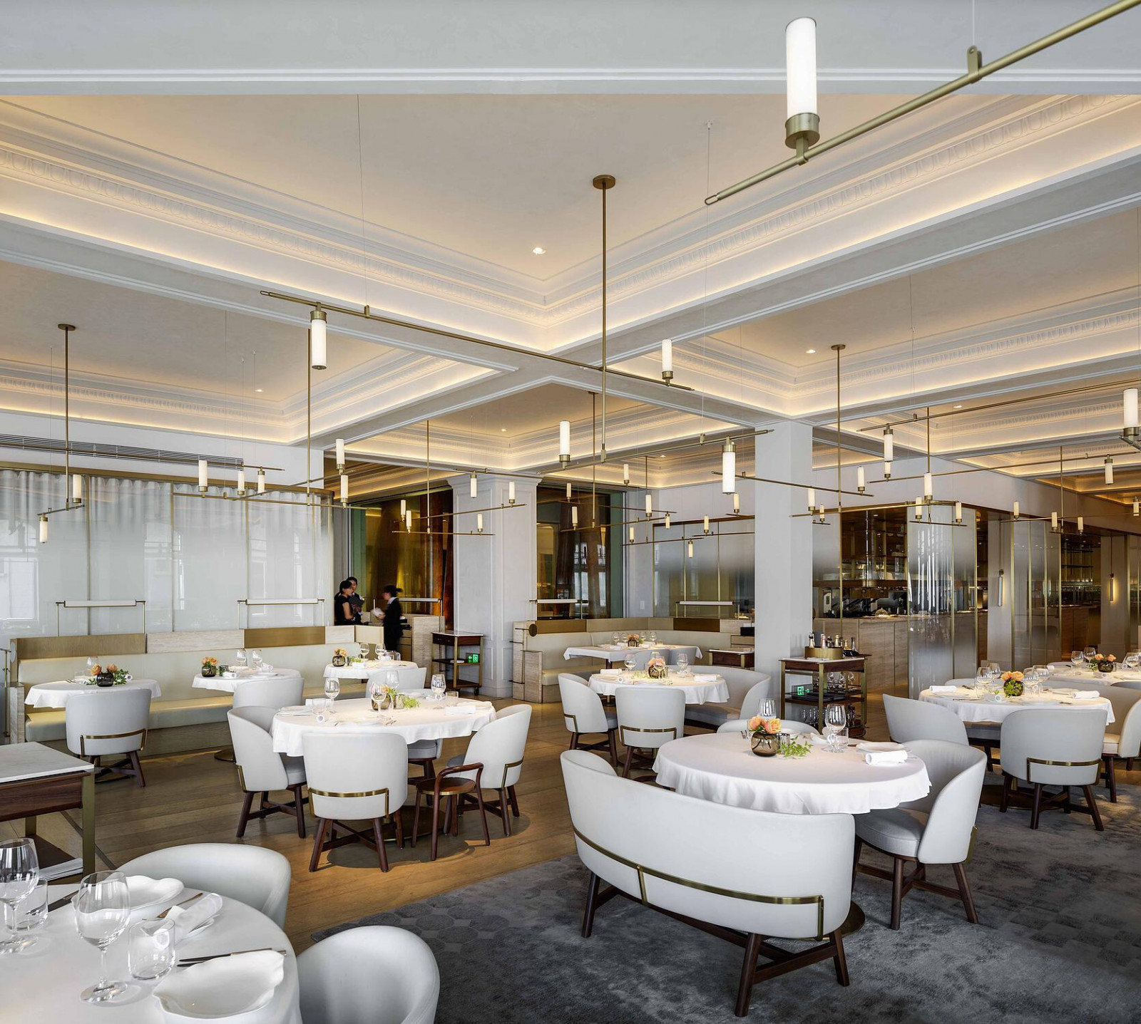 The main dining room of Jean-Georges at Three on the Bund, with the building's original coffered plaster ceiling and cornice mouldings preserved above Neri&Hu's contemporary interior