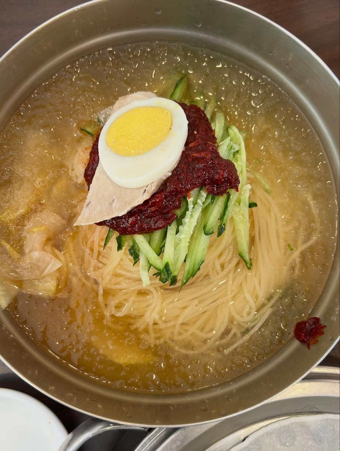 Cold wheat noodles in a light, tangy broth, garnished with cucumber, radish and boiled egg, ideal for warm-weather dining (Photo: fooddudeph/Instagram)