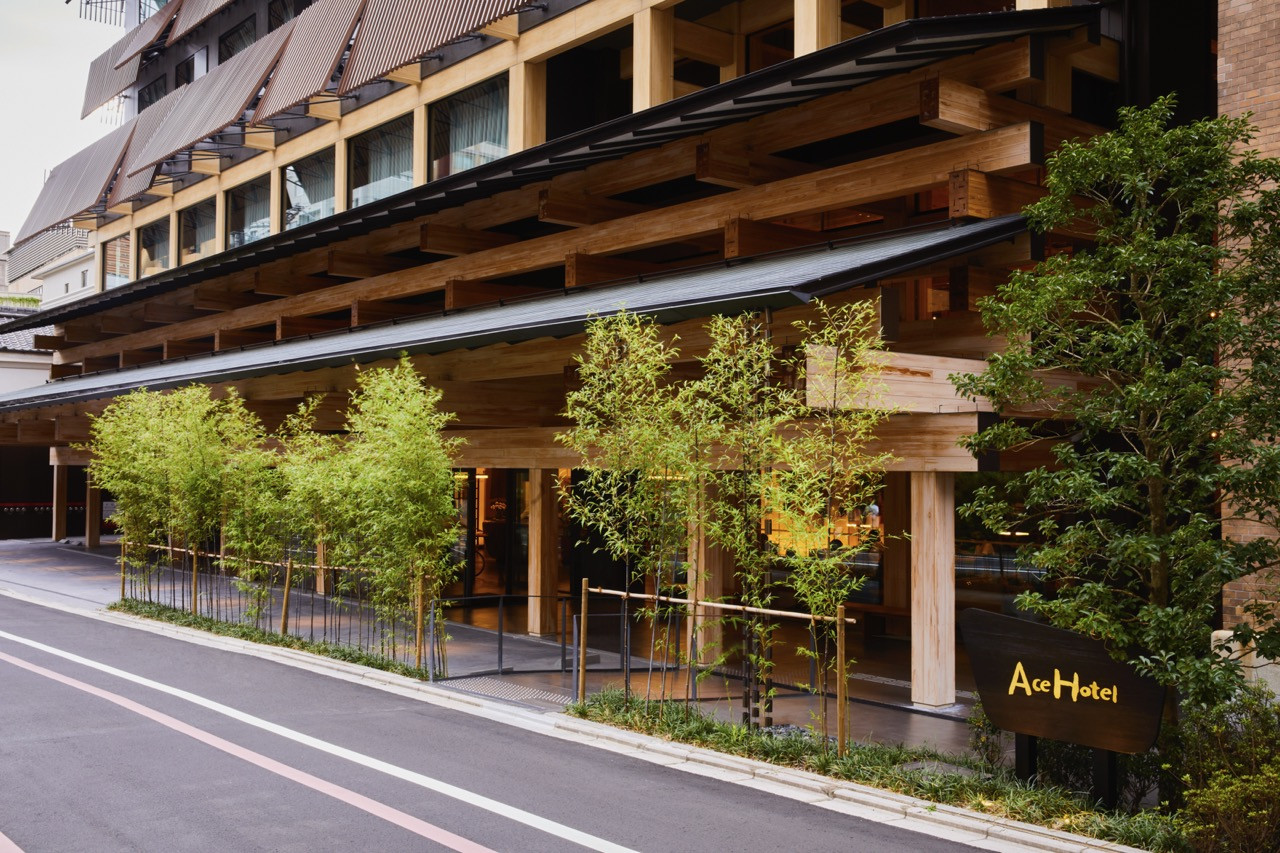 The entrance canopy of Ace Hotel Kyoto’s new building, designed by Kengo Kuma with layered timber structure referencing traditional Japanese architectural detailing