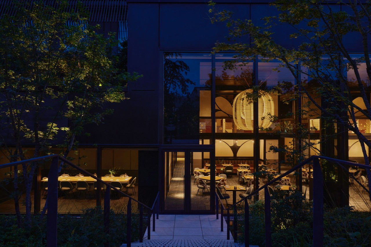 The Kosa restaurant at Ace Hotel Kyoto at night, set within the new building alongside the 1926 heritage telephone exchange