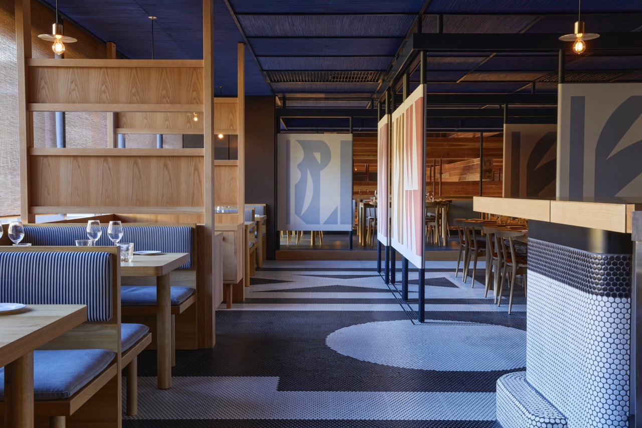 The dining room of Mr Maurice’s Italian at Ace Hotel Kyoto, with Japanese craft references in the timber joinery and hand-painted artworks throughout