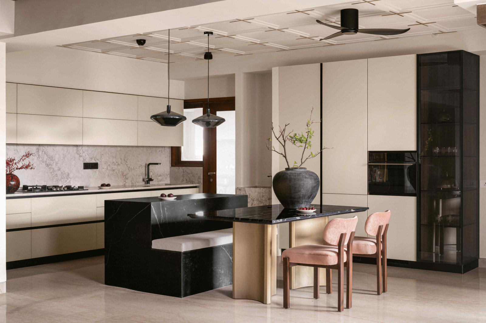 In the beige-toned kitchen, a Dekton island counter anchors the space
