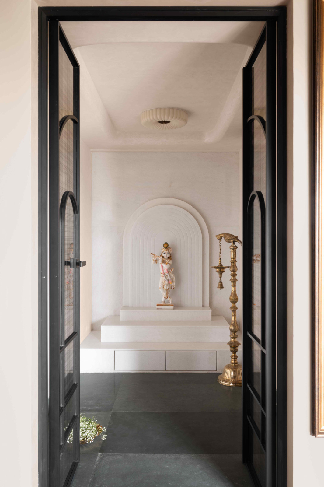 A serene interior lined with white marble surfaces and delicate ceiling contours