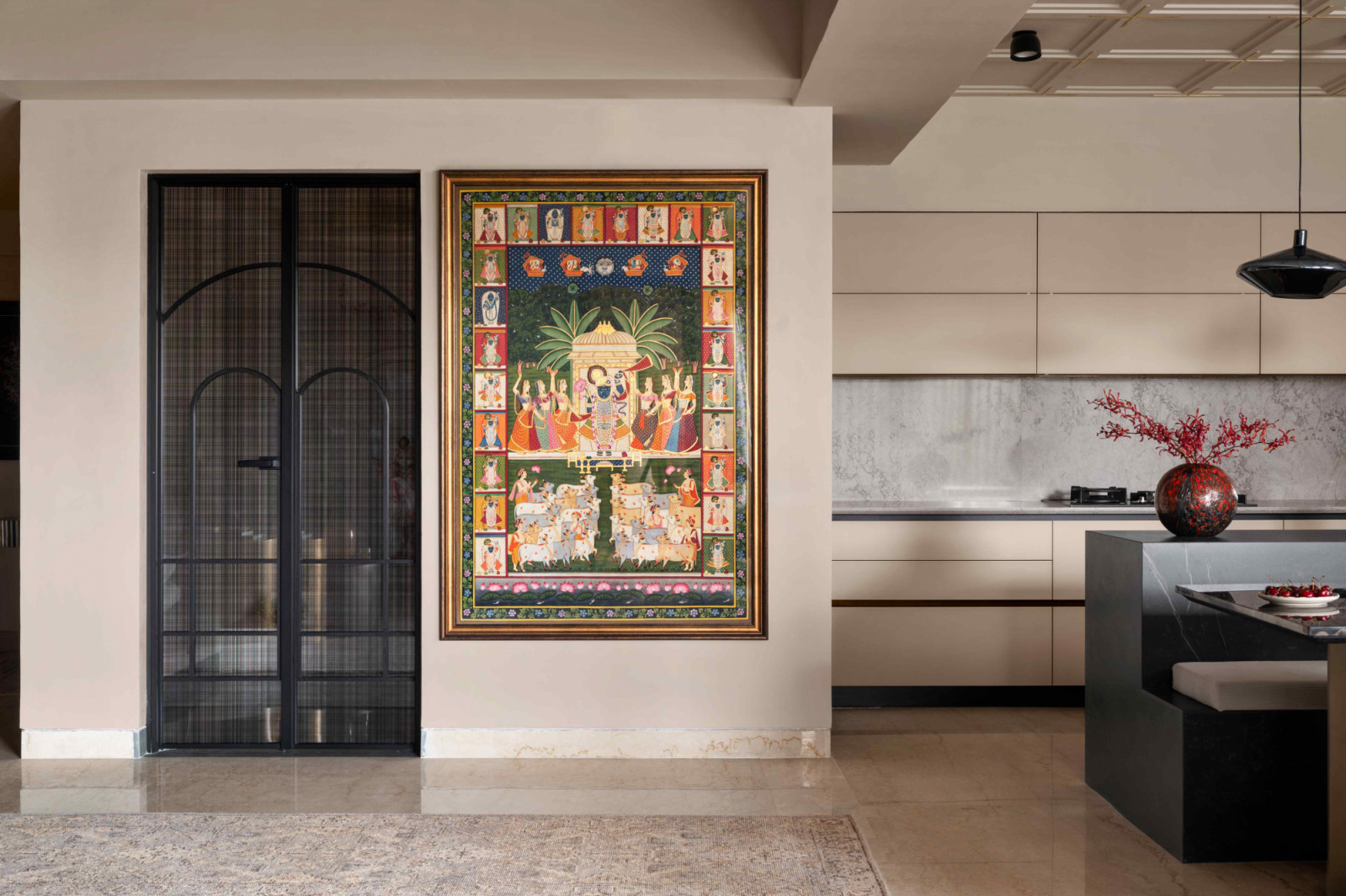 The pooja alcove with an aluminium-framed door with arched detailing