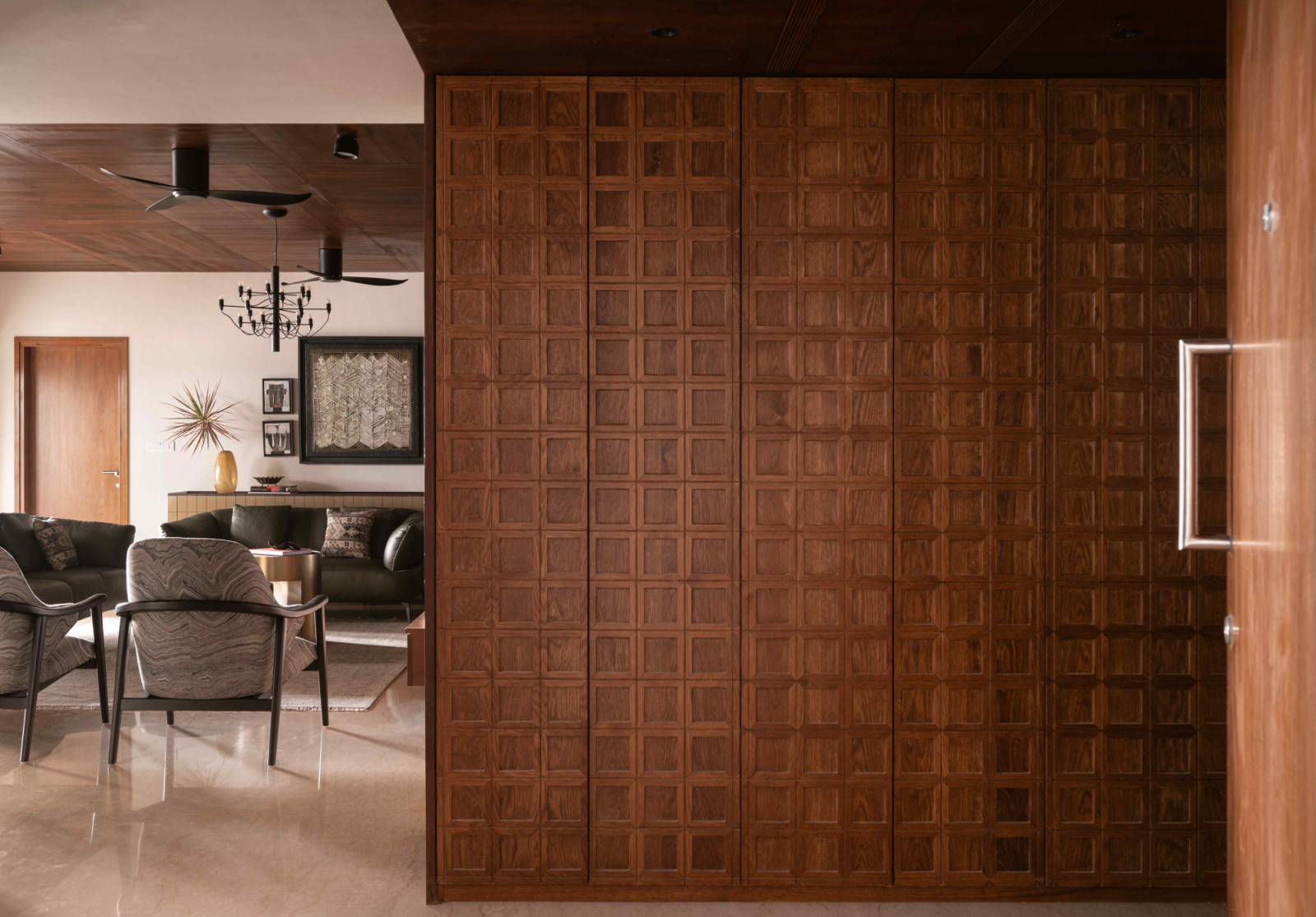 The wood-panelled wall with recurring grid motifs