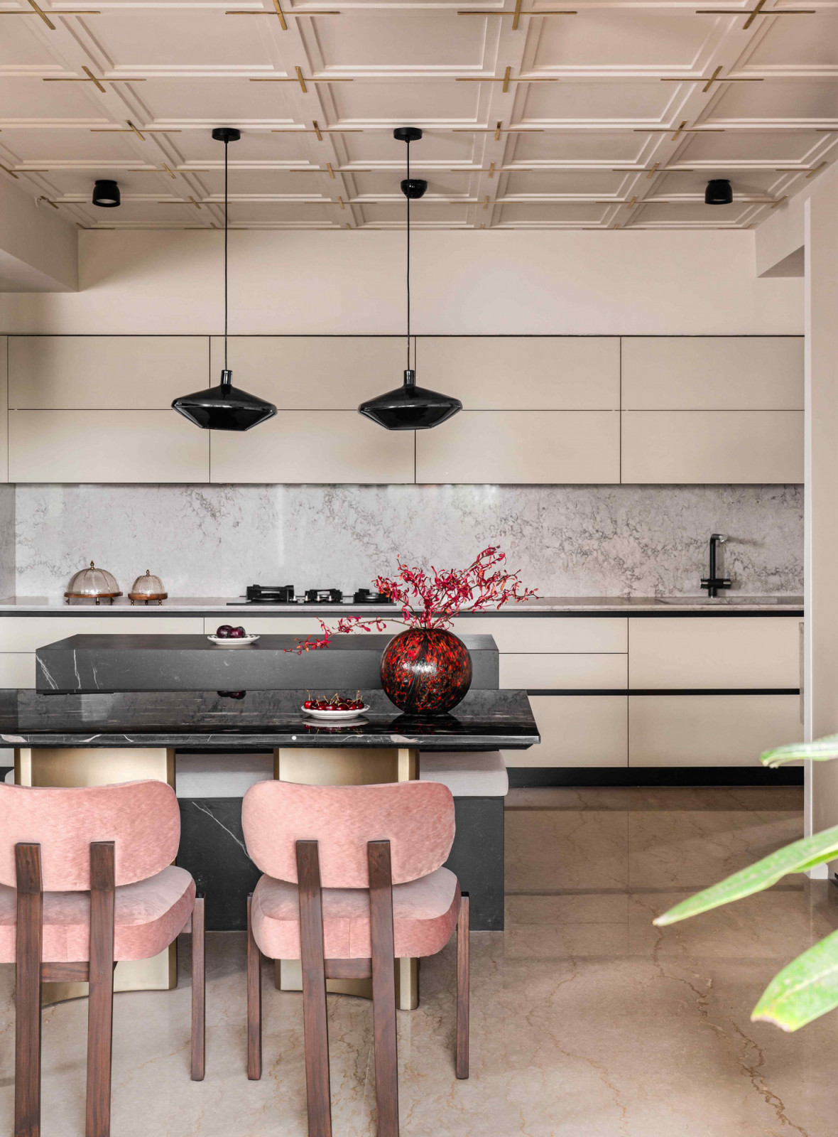 Blush-pink dining chairs introduce a whimsical contrast to the neutral palette
