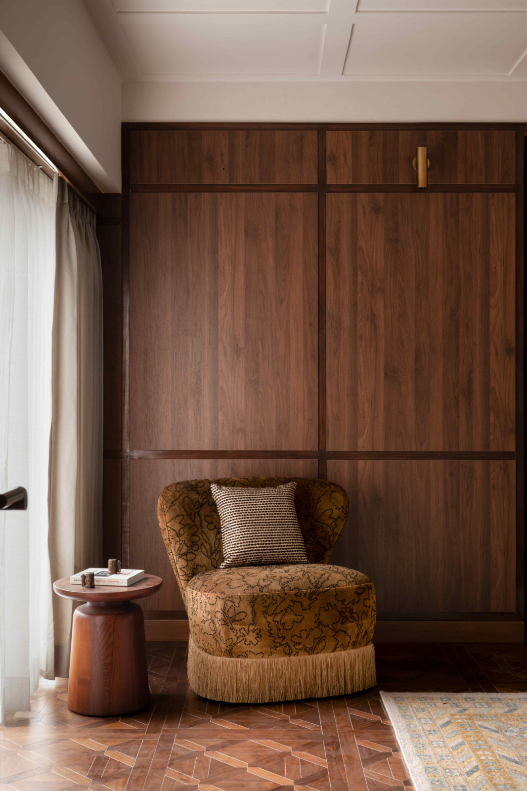 A mustard swivel chair in the corner offers a sunlit retreat
