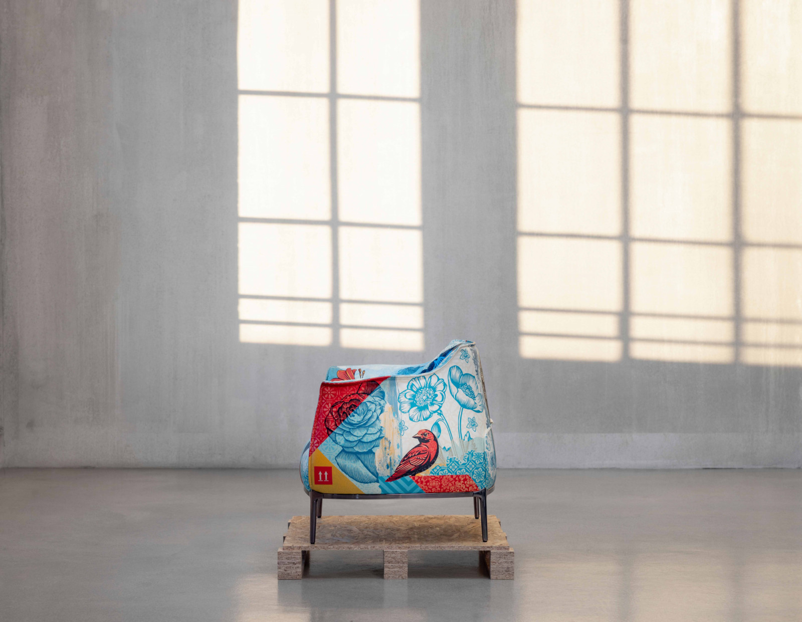 A rose and botanical motifs bloom across the chair’s sculptural profile in the Delicate Balance artwork