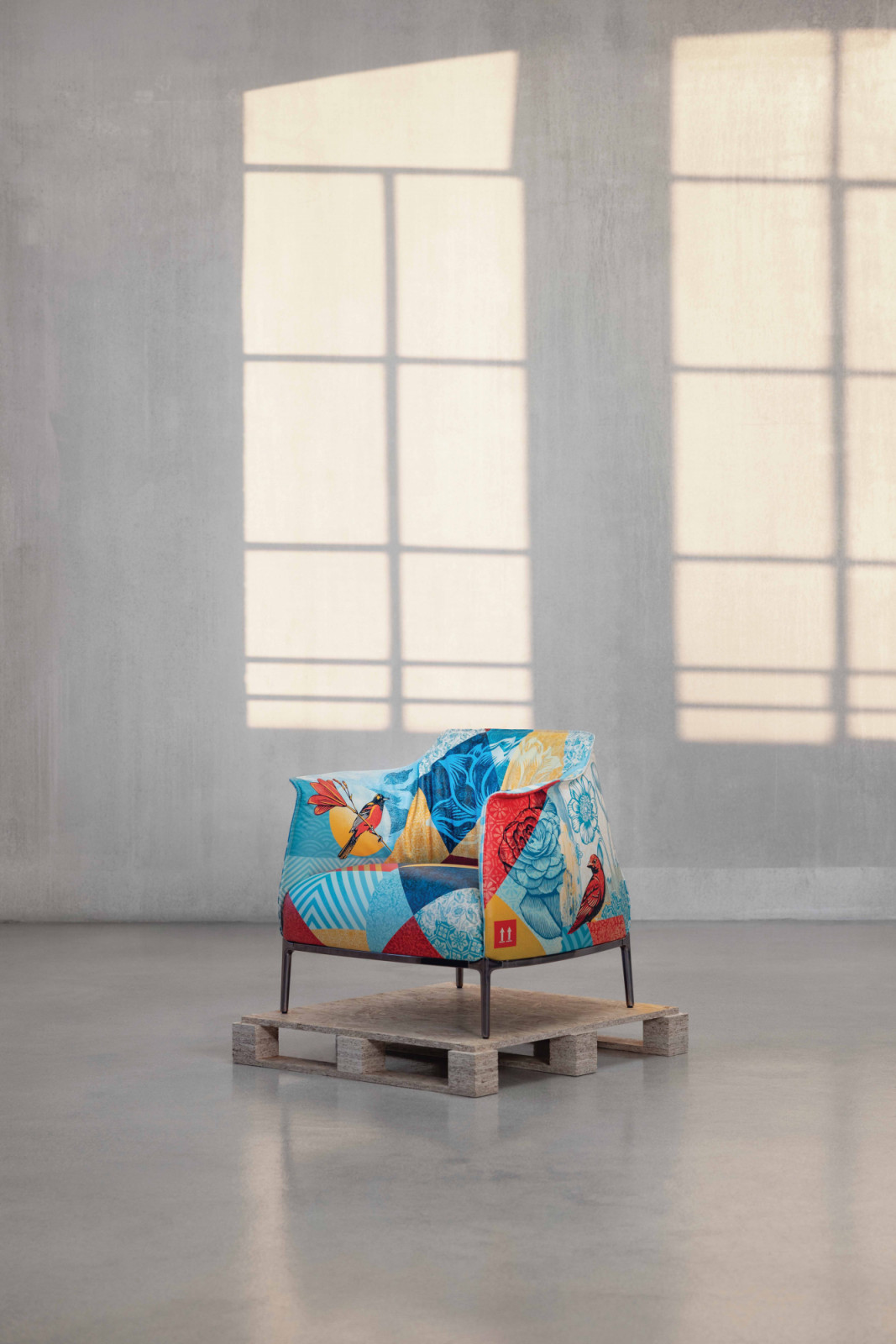 Shepard Fairey’s signature palette of blue, red and yellow graphic panels unfolds across the Archibald Delicate Balance armchair