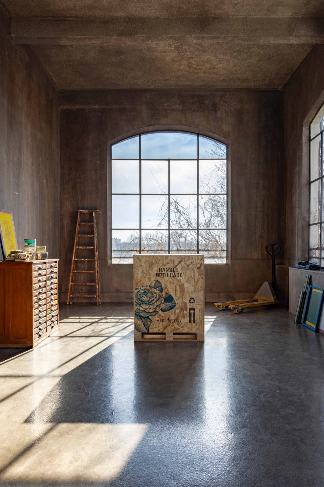 Adorned with Shepard Fairey’s blue rose motif, the shipping crate itself becomes a collectible design object