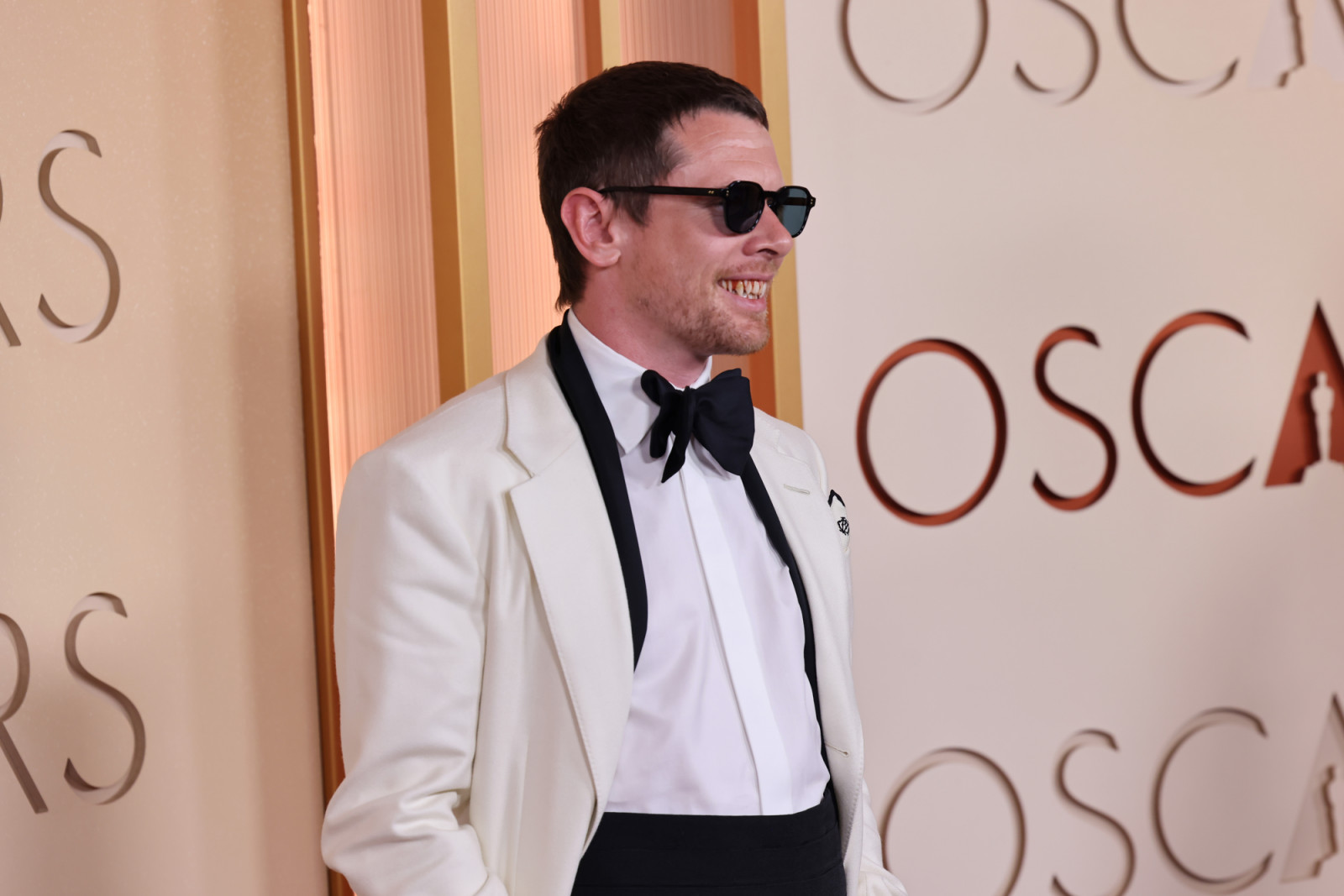 Jack O’Connell wore a classic tuxedo with minimal grooming and added a playful touch with vampire fangs nodding to his recent film roles (Photo: Julian Hamilton/Getty Images)