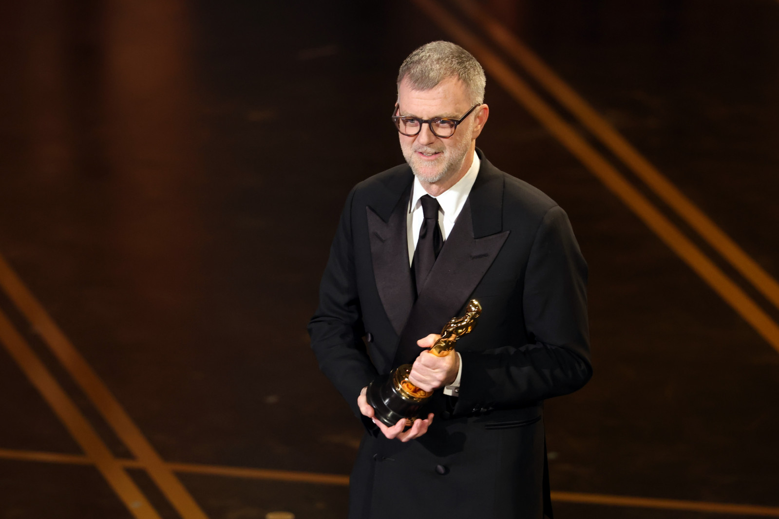 HOLLYWOOD, CALIFORNIA - MARCH 15: Paul Thomas Anderson accepts the Writing (Adapted Screenplay) award for "One Battle After Another" onstage during the 98th Oscars at Dolby Theatre on March 15, 2026 in Hollywood, California. (Photo by Kevin Winter/Getty Images)