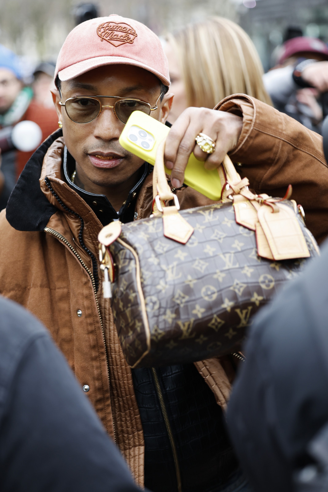 PARIS, FRANCE - JANUARY 26: Pharrell Williams wears brown Carhartt jacket, black leather jacket, pink denim cap, Louis Vuitton bag, outside Sacai, during the Menswear Fall Winter 2025/2026 as part of Paris Fashion Week on January 26, 2025 in Paris, France. (Photo by Claudio Lavenia/Getty Images)