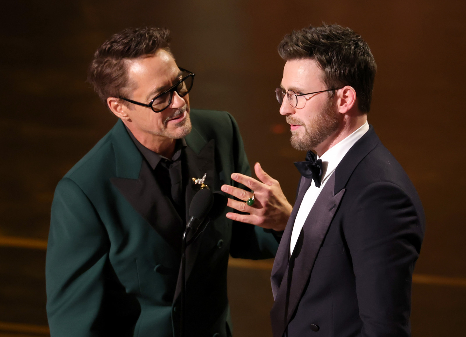 Robert Downey Jr and Chris Evans speak onstage (Photo: courtesy of Kevin Winter/Getty Images)