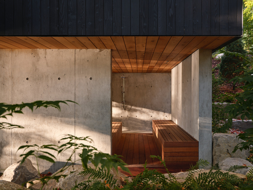 The onsen-inspired outdoor bathing area is set beneath an eight-foot cedar ceiling between poured concrete walls