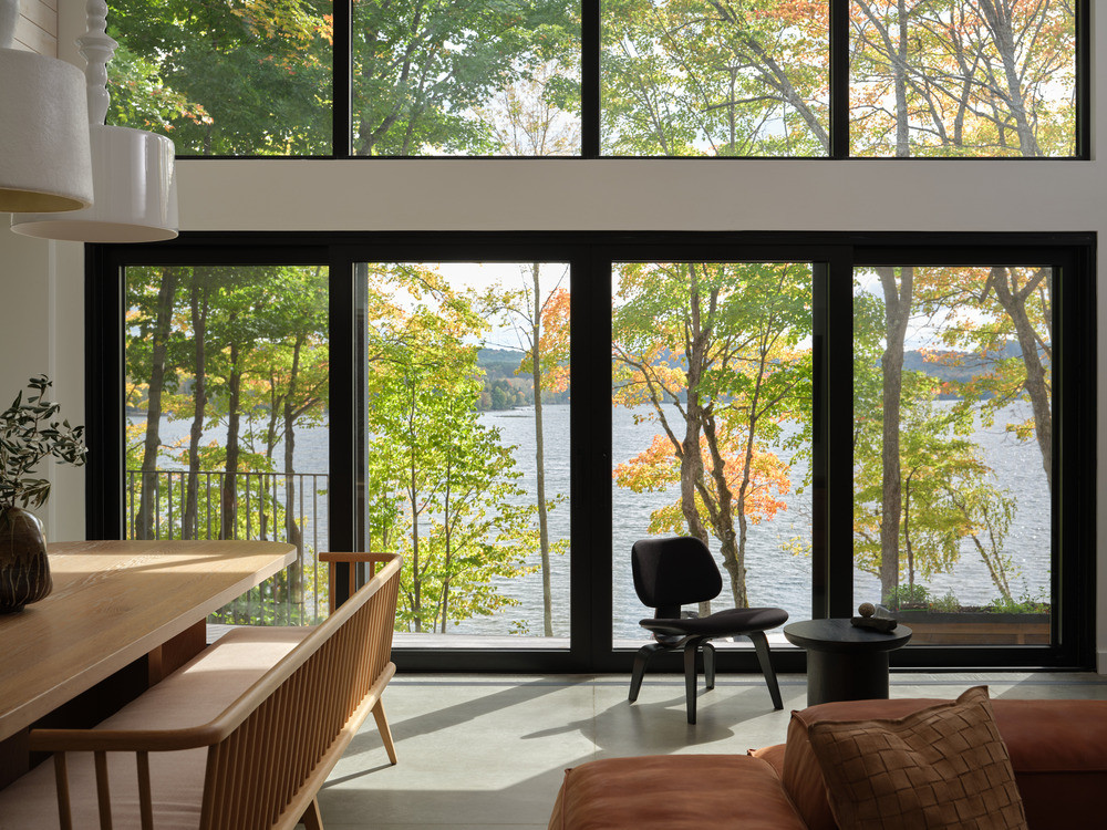 The lower-level living and dining area oriented towards the lake through two rows of full-height glazing