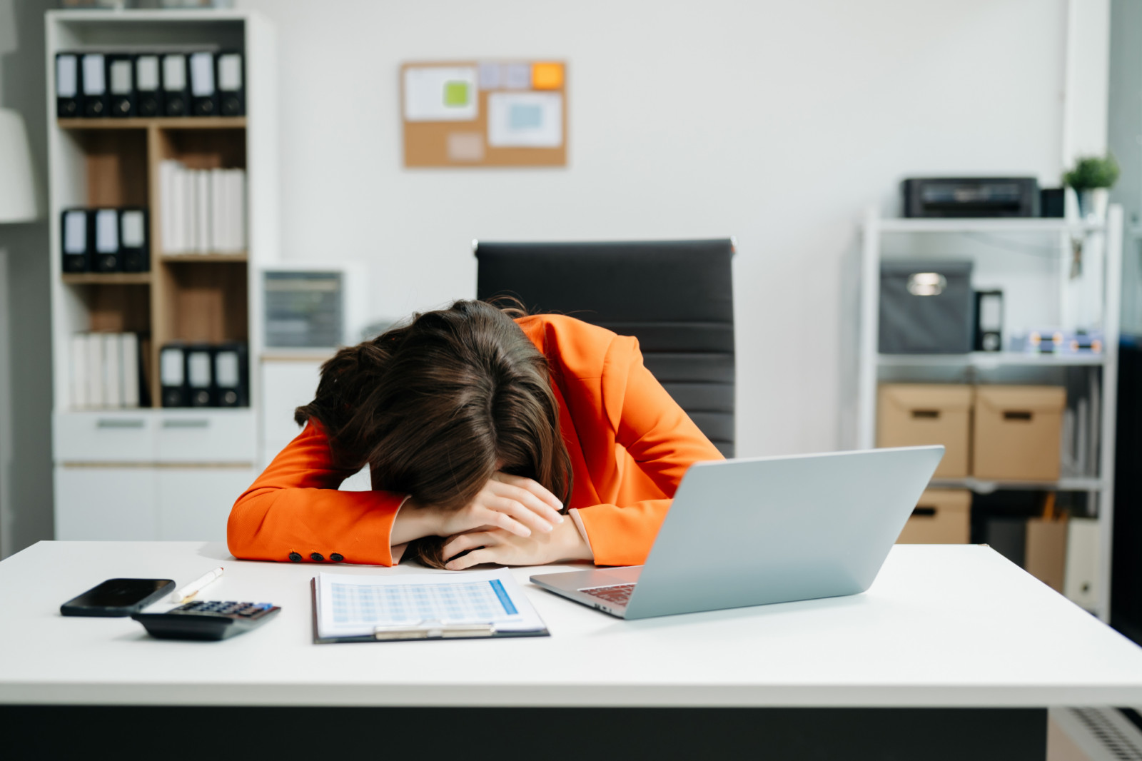 business woman is stressed, bored, and overthinking from working on a tablet at the office.