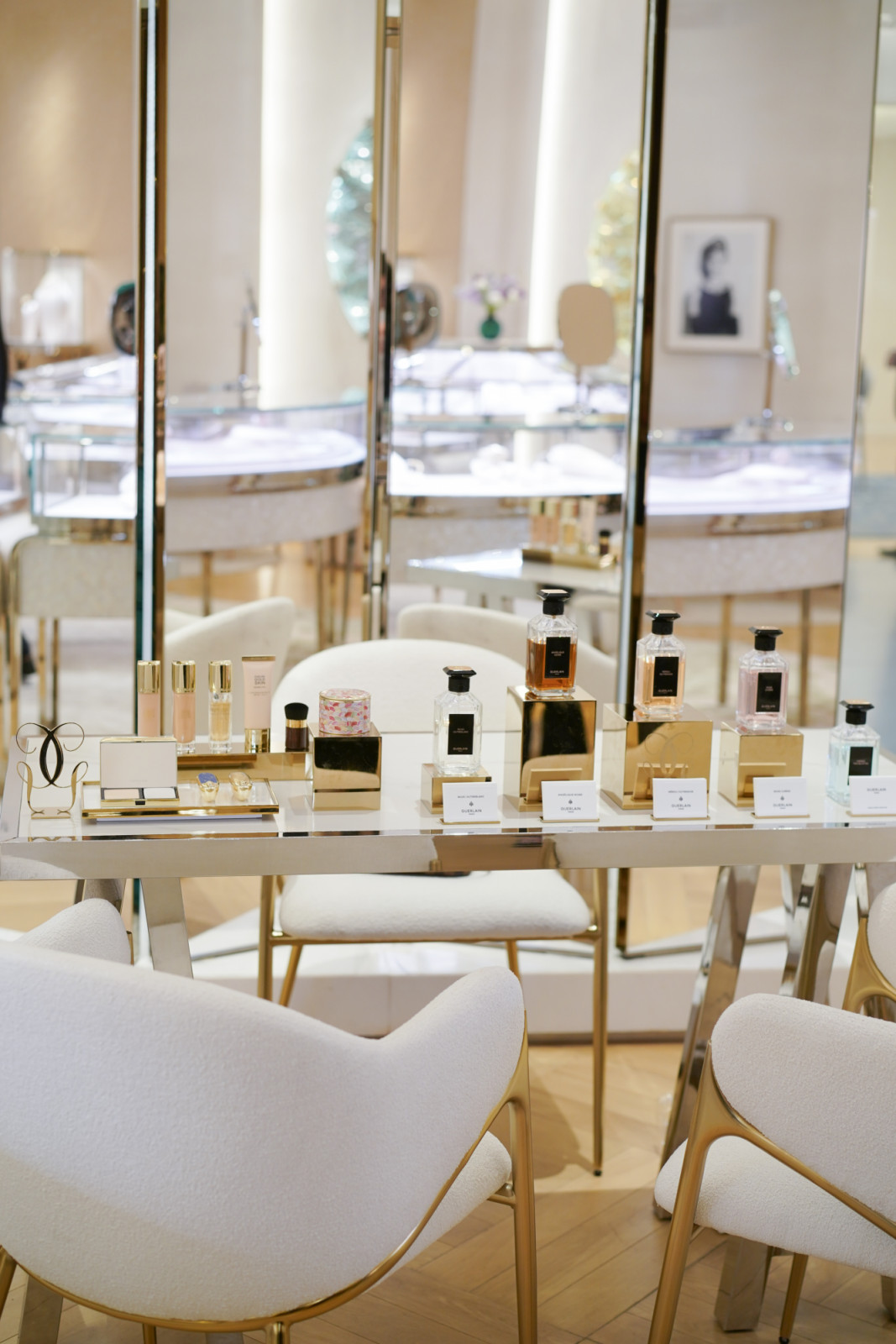 Guests explore the beauty station by Guerlain, discovering scents and essentials.