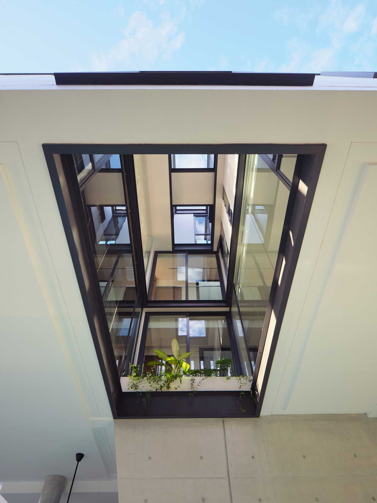 A multi-level void connects the rooms across floors