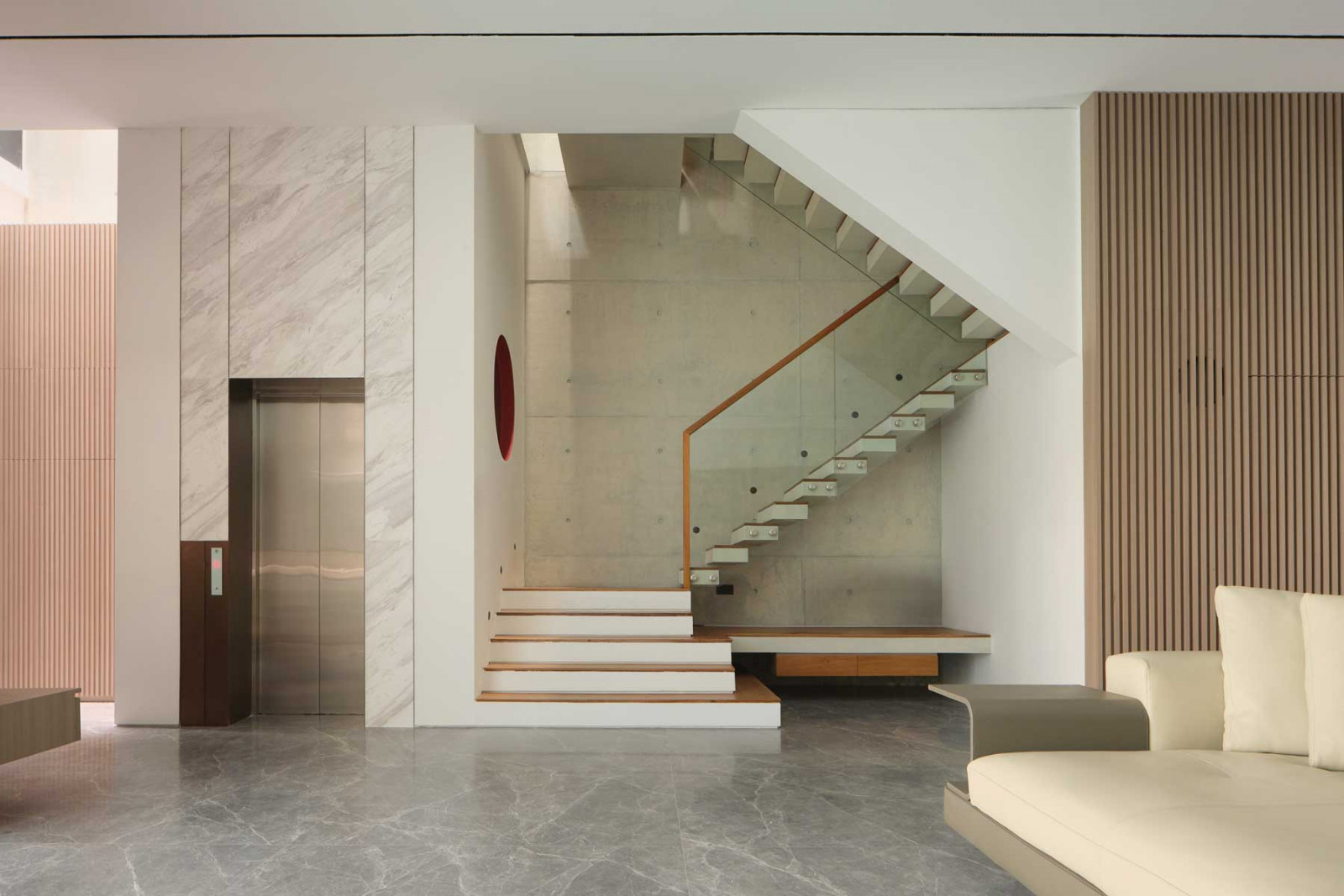 Envisioned as a retiree’s forever home, the house is designed for ease of maintenance, mobility and tranquillity, as seen in this living room with convenient access to the lift and stairwell along the party wall