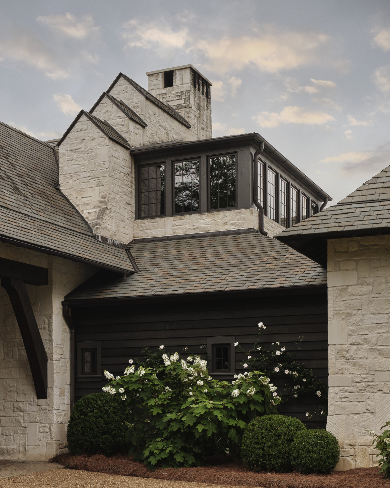 Dark timber cladding contrasts light-coloured Texas limestone