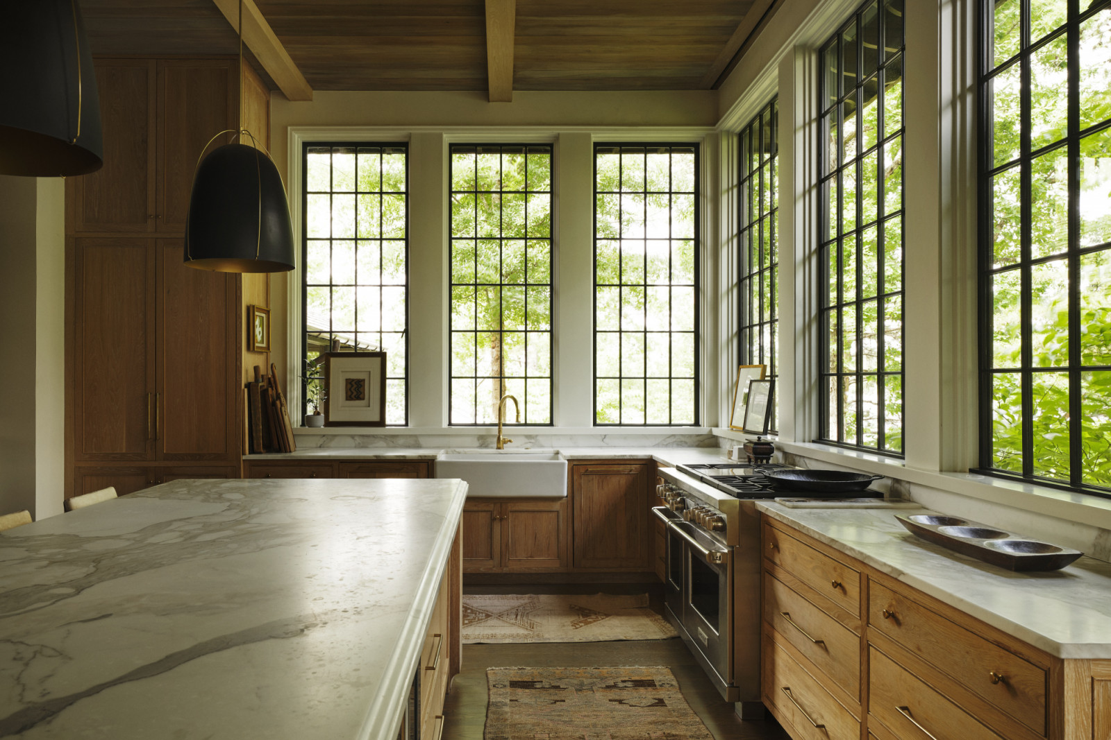 The light-filled kitchen with tactile stone surfaces and natural wood grains