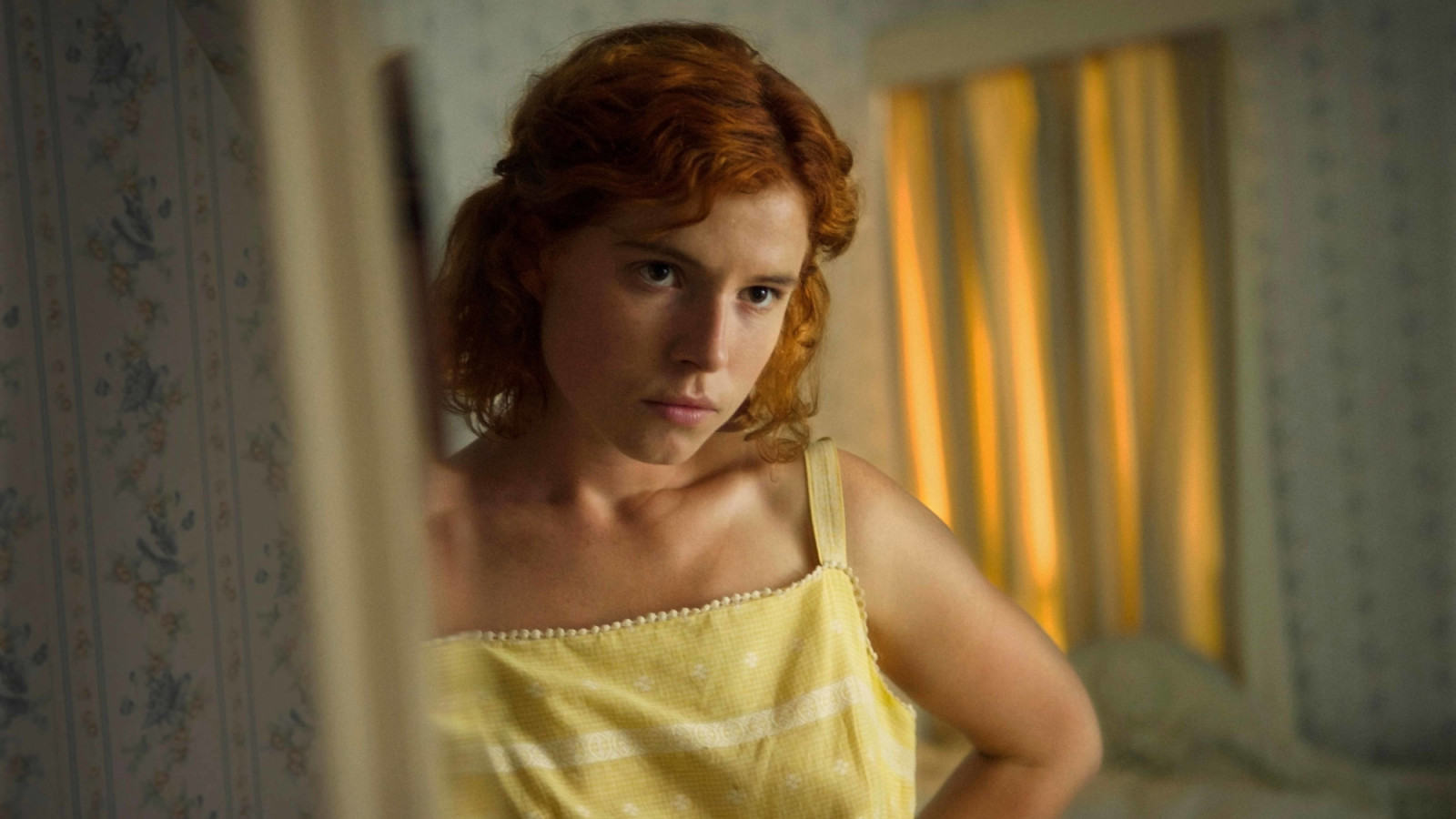Moll (Jessie Buckley) gets ready to go out in the thriller <em>Beast</em>