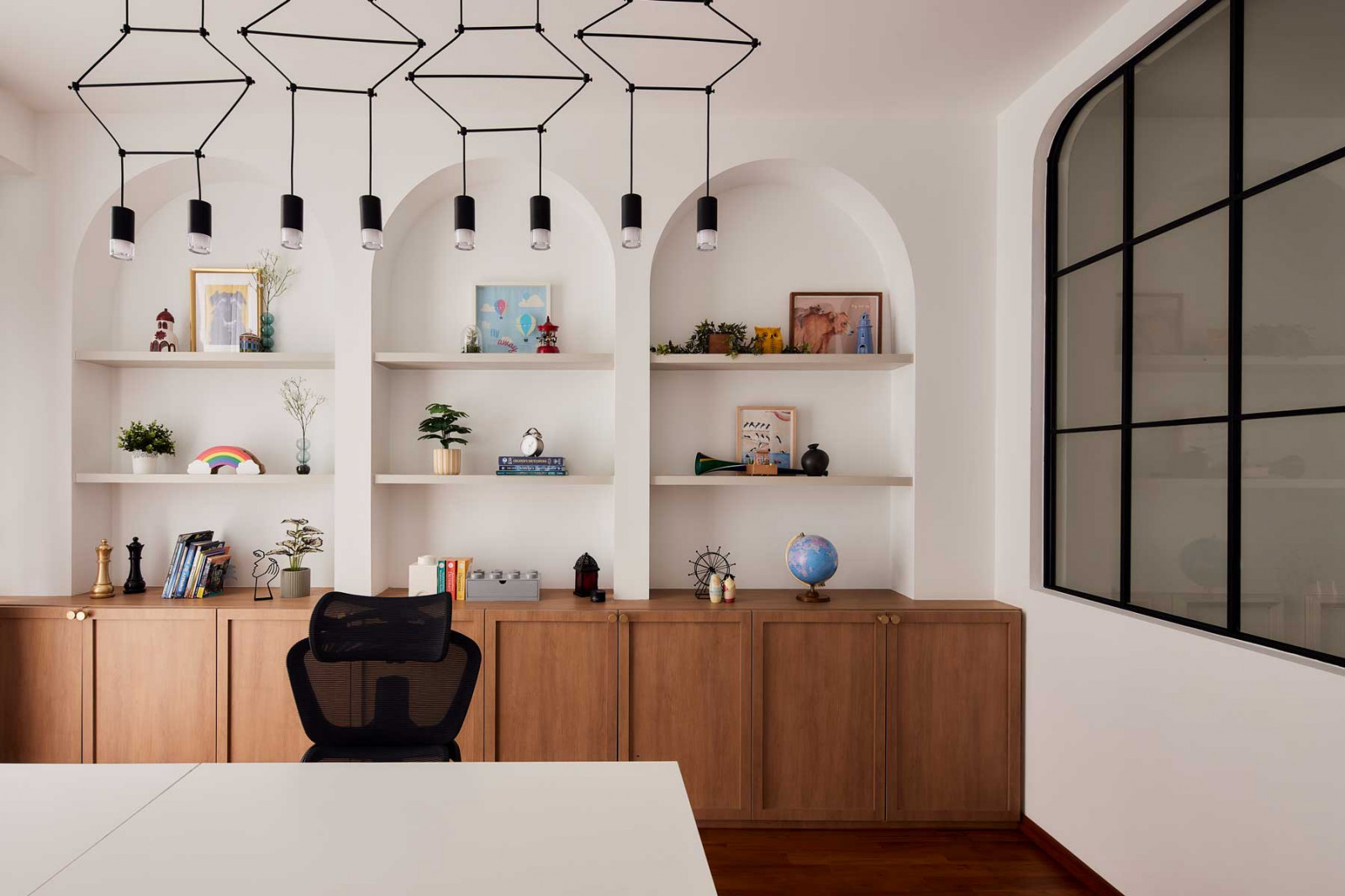 A soft palette of whites, wood tones and warm metals is used throughout the home