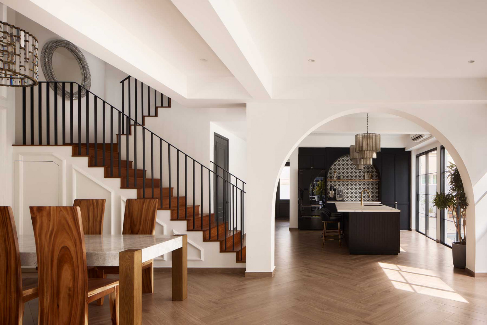 Panel mouldings, arched openings and warm timber flooring introduce a sense of familiarity and heritage