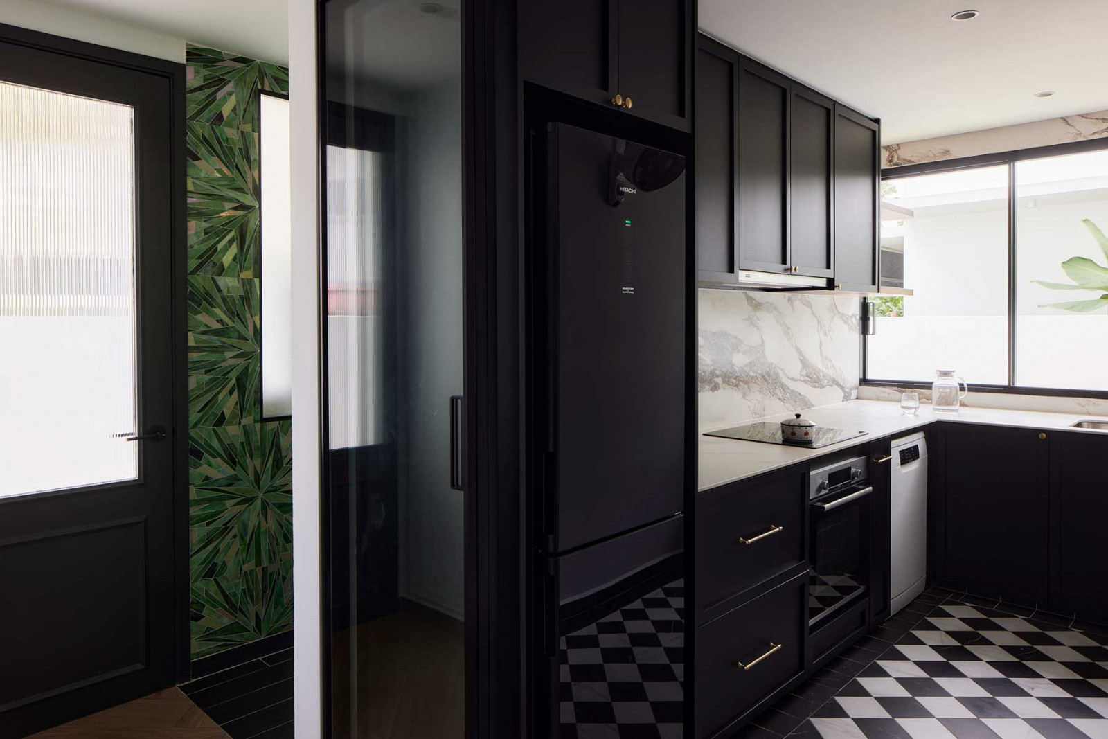 Bold patterned wallpaper is used throughout the house, alongside dark cabinetry for a distinctly European feel