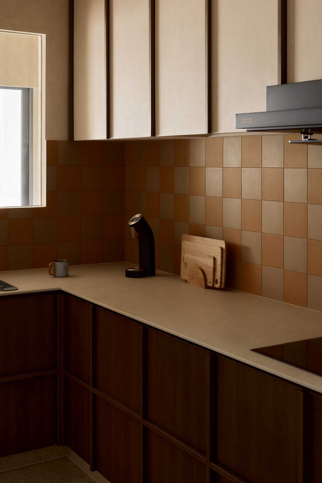 Textured tiles and terrazzo surfaces add tactile interest in the kitchen and bathrooms