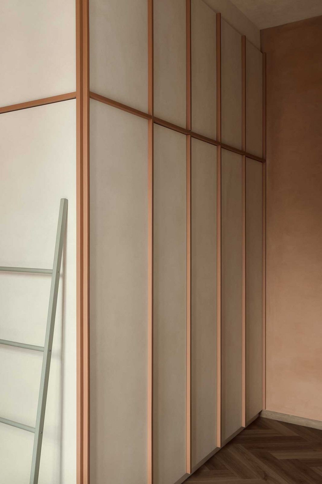 Herringbone timber flooring introduces a sense of craftsmanship and movement across the living areas