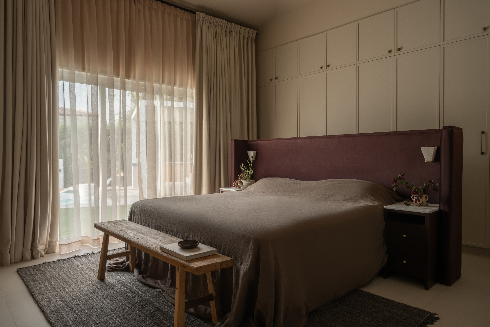 Muted earth tones in the bedroom of a Dubai family home designed by Amna Chaudhry Interiors
