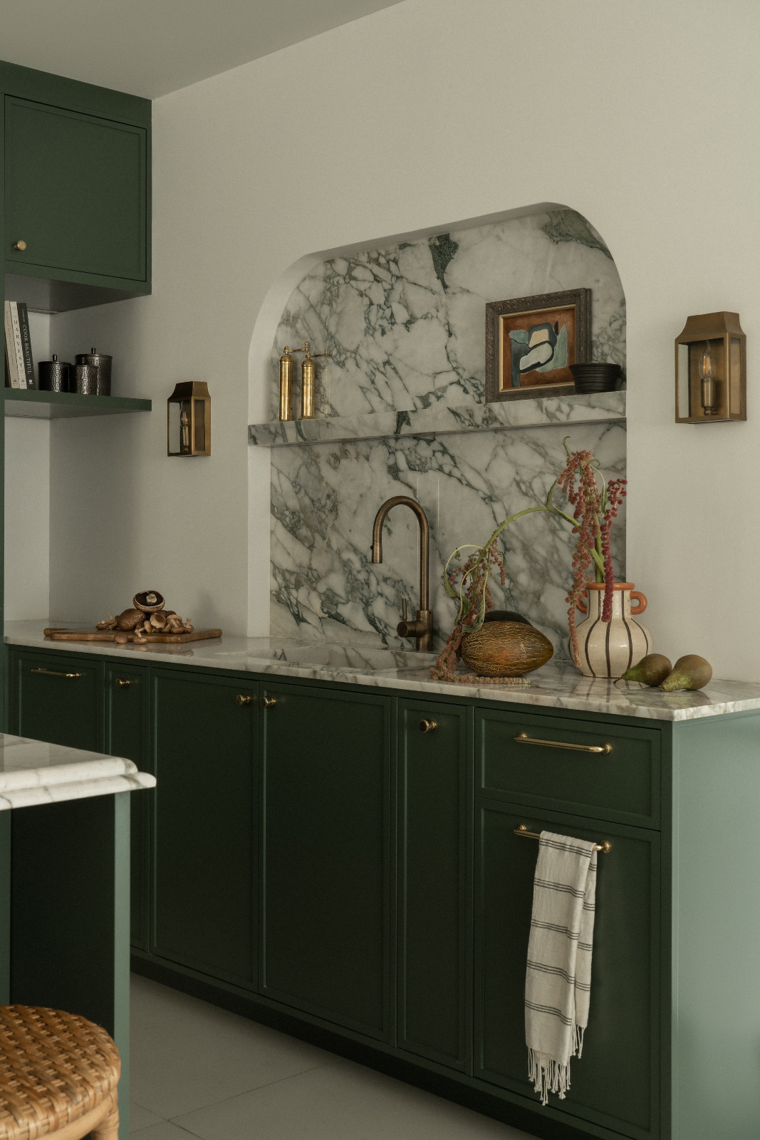 The green hues and marble accents of the kitchen in a Dubai family home designed by Amna Chaudry Interiors
