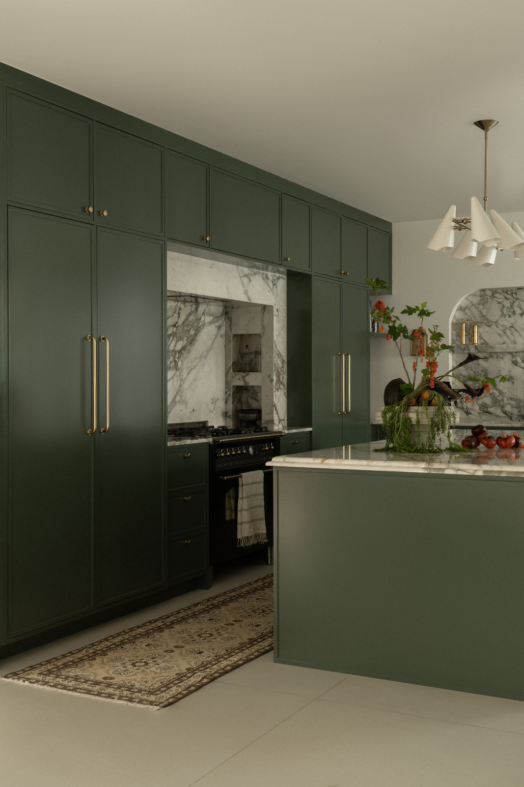 The green hues and marble accents of the kitchen in a Dubai family home designed by Amna Chaudry Interiors