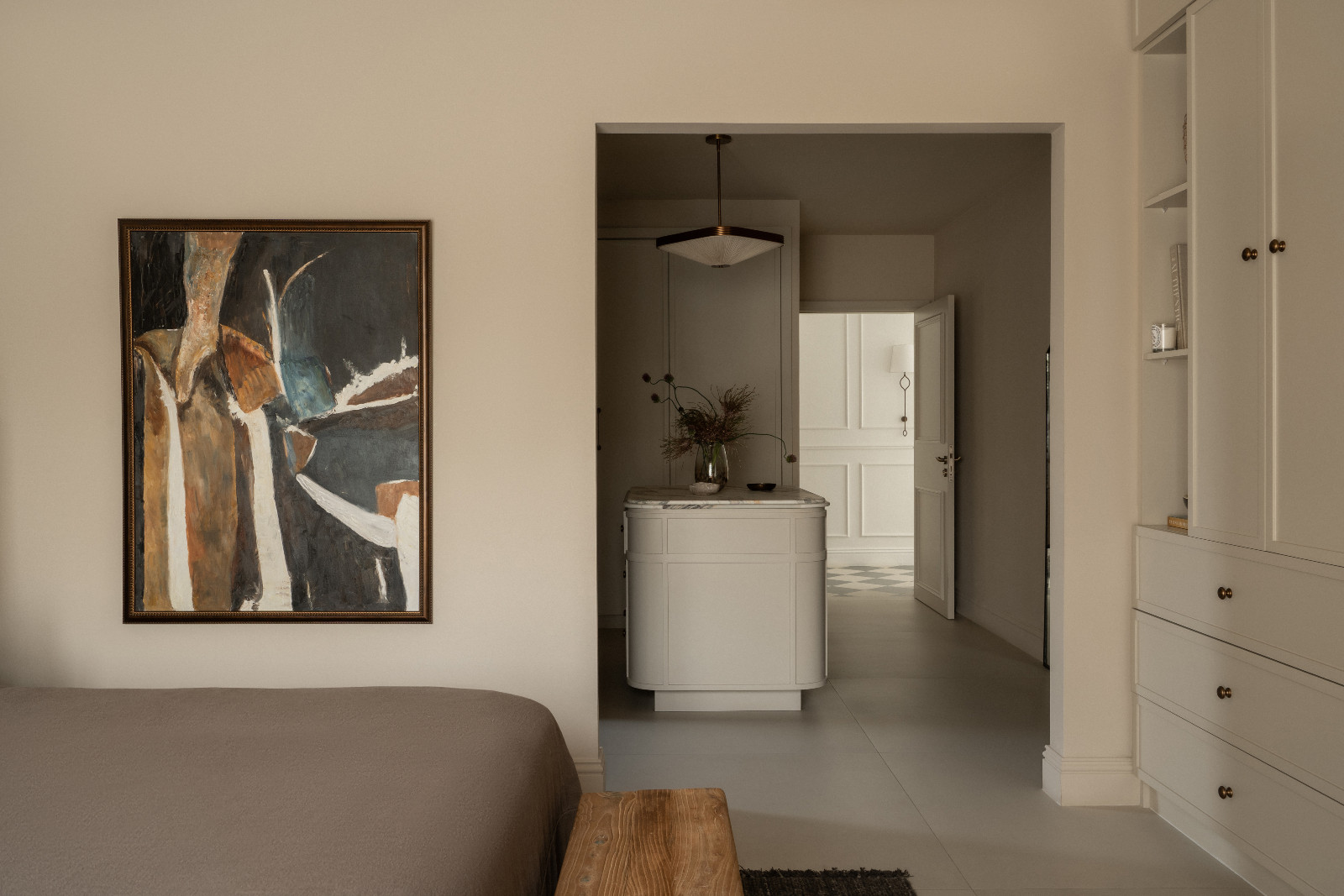Muted earth tones in the bedroom of a Dubai family home designed by Amna Chaudry Interiors