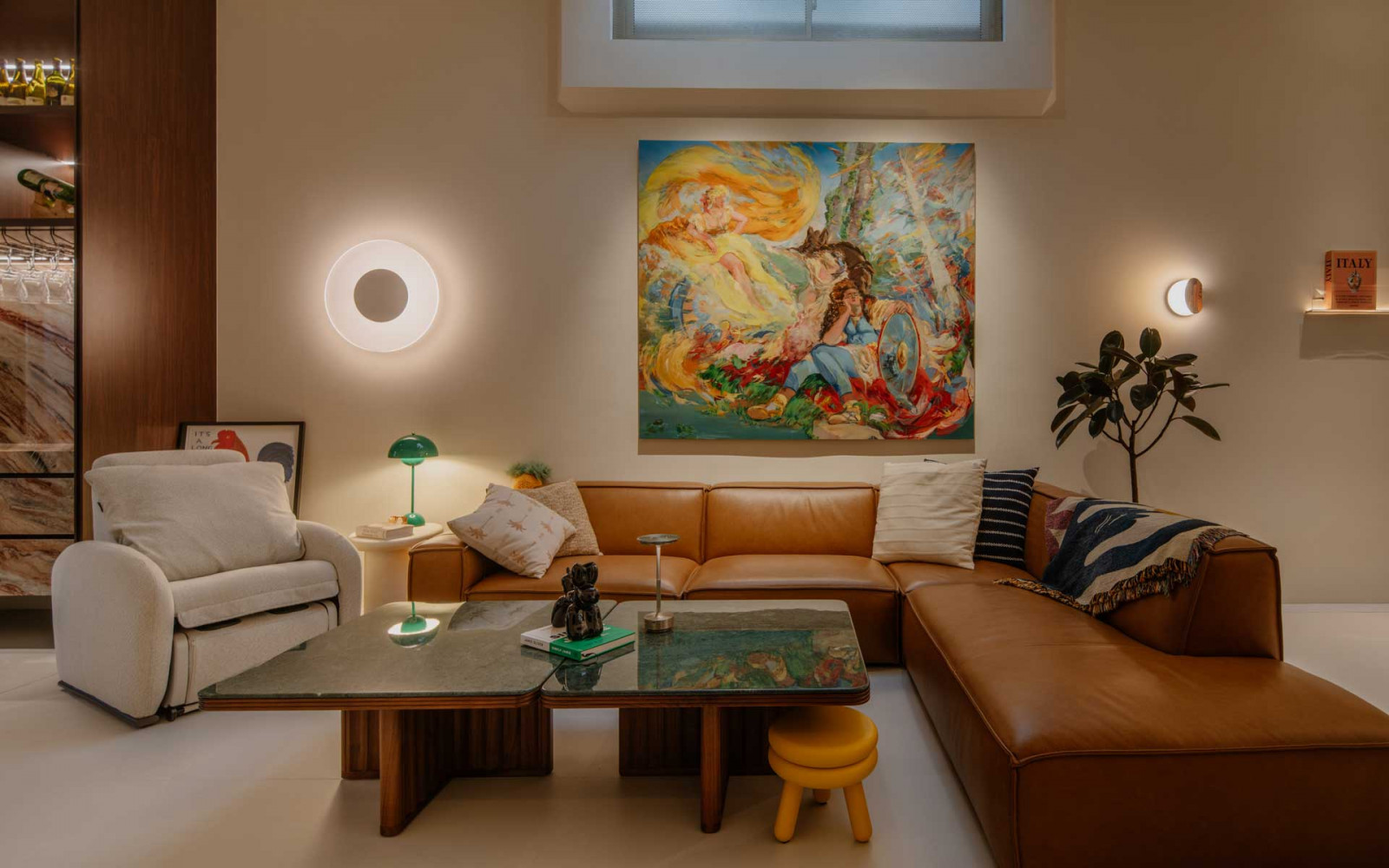 The living area is anchored by another colourful painting