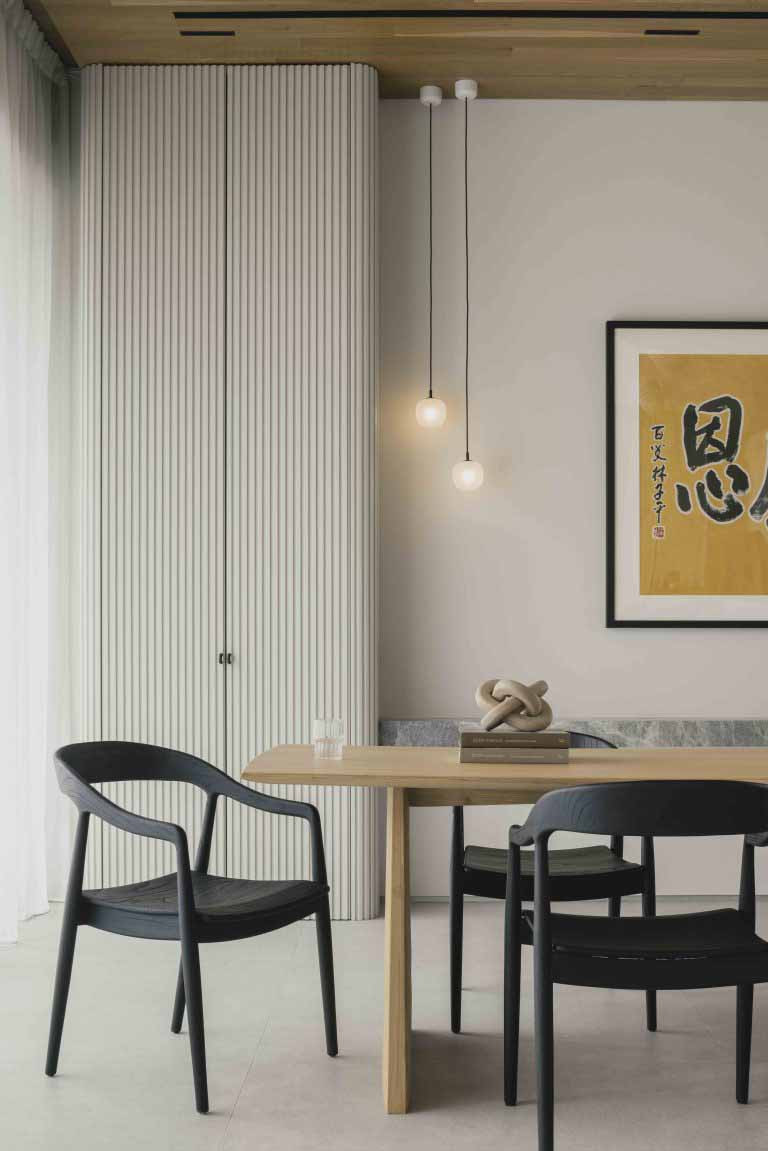 The dining area features a fluted column detail and is positioned within the second-storey living zone for natural light and ventilation