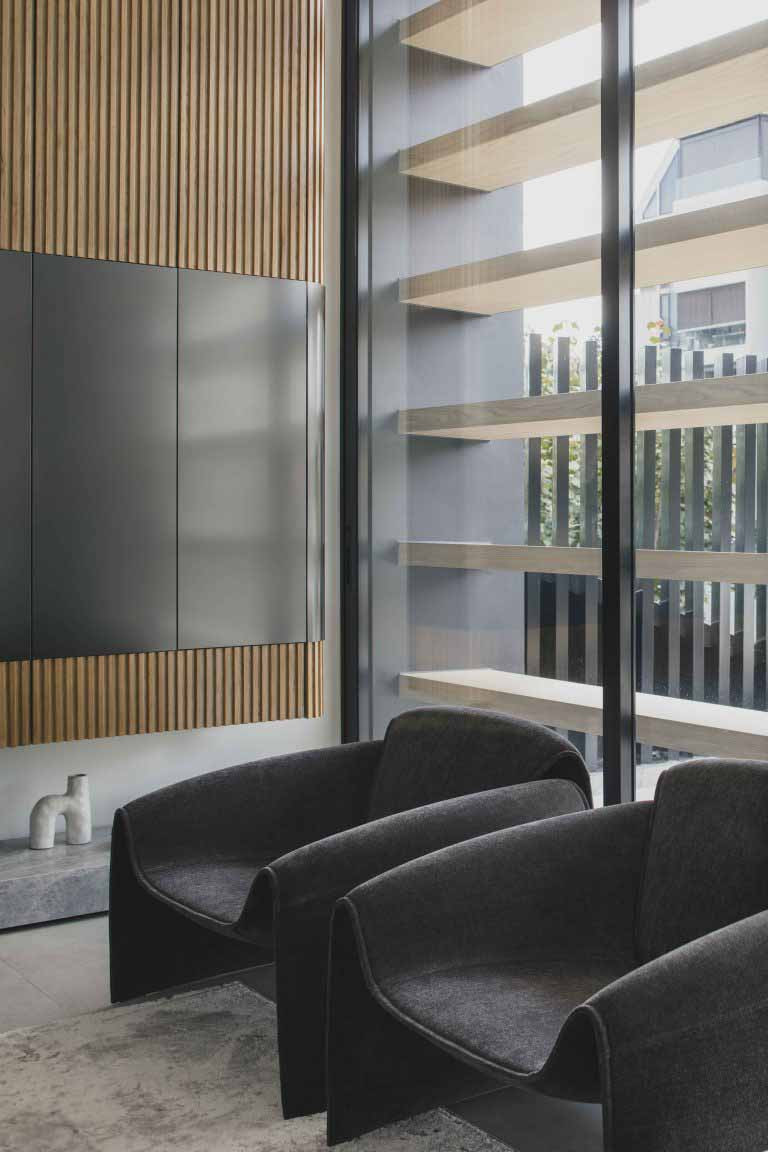 The lounge sits behind sliding glass doors and external screens