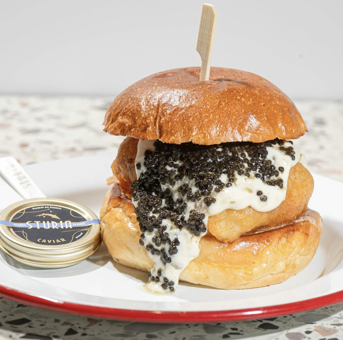 A crispy fried halibut fish burger from 717 Deli (with caviar) | Photo: 717deli / Instagram