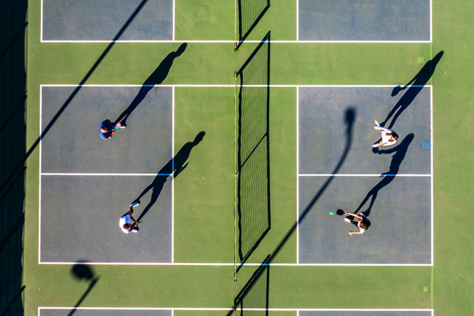 Group of hispanic friends playing pickleball