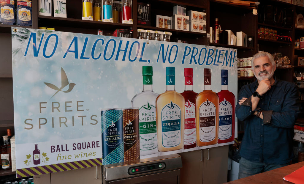 Somerville, MA - January 23: Chris Lianos, right, owner of Ball Square Fine Wines, intends to display this signage in his store window. "Dry January" is a trend, and Lianos stocks non-alcoholic alternatives to all his alcoholic products. (Photo by Pat Greenhouse/The Boston Globe via Getty Images)