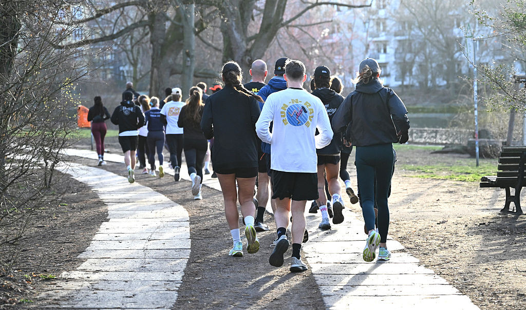 12 March 2026, Berlin: Runners from the "RUN-N-RAVE" running club run along the Görlitzer Ufer. Every Thursday at seven in the morning, the running club in Berlin meets to run, dance and then work together. The focus is less on the sporting challenge and more on fun and togetherness. Photo: Elisa Schu/dpa (Photo by Elisa Schu/picture alliance via Getty Images)