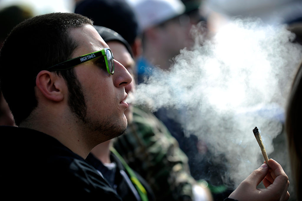 DENVER, CO - APRIL 19: A man exhales marijuana smoke during the High Times Cannabis Cup at the Denver Mart in Denver, Colorado on April 19, 2015. The High Times Cannabis Cup runs through Monday at the Denver Mart. (Photo by Seth McConnell/The Denver Post via Getty Images)