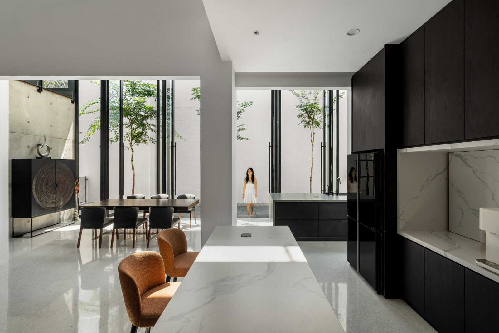 The original house interior connects to the new hall through an opening at ground level