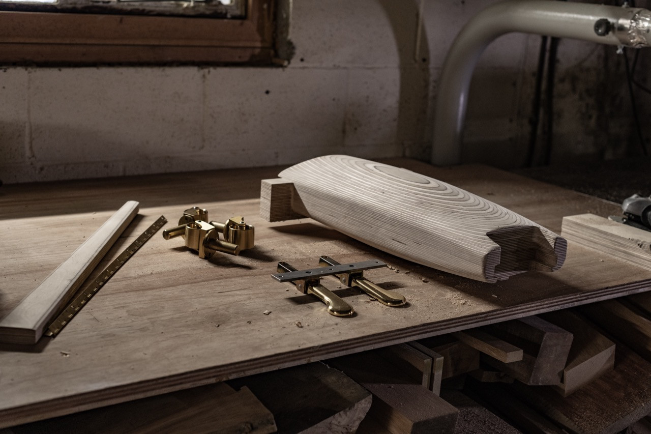 Birchwood components and brass hardware on a workbench at the Edelweiss workshop
