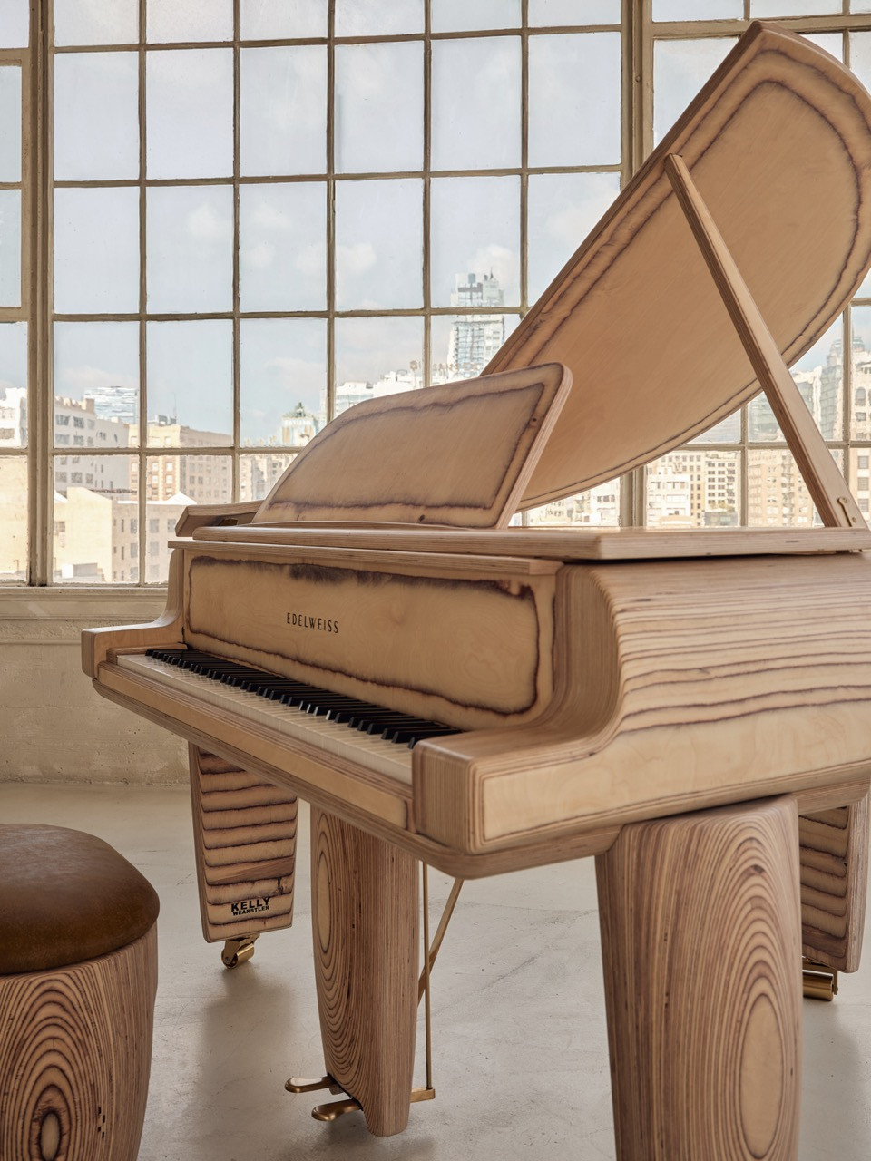 The Timbra piano and stool, with the Kelly Wearstler branding visible on the pedal lyre