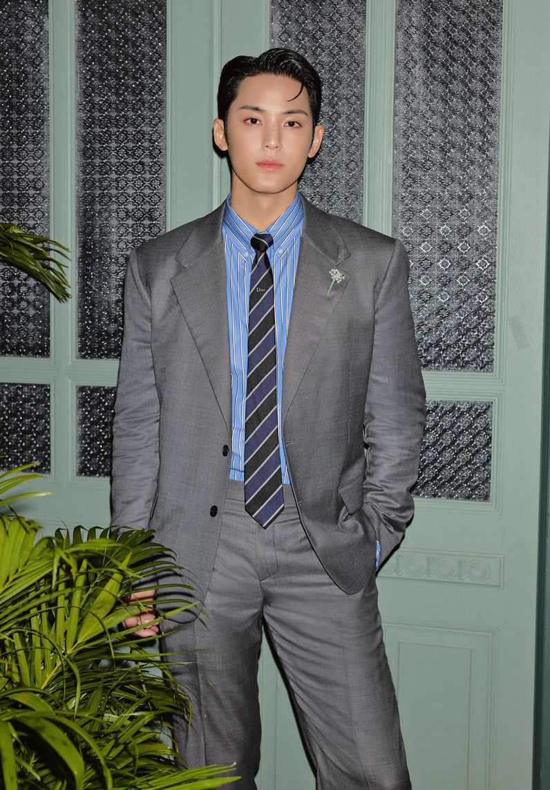 Mingyu subverts corporate dressing with a floral lapel pin on a structured grey Dior suit (Photo: @min9yu_k/Instagram)