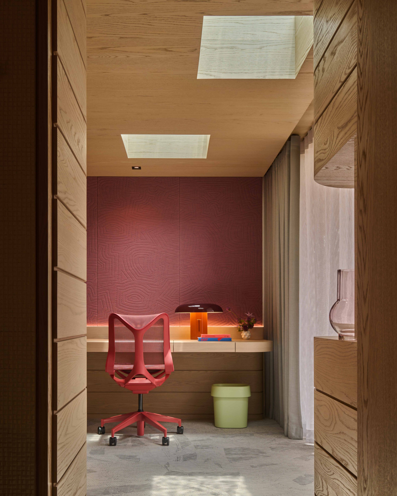 A pink-washed wall and Herman Miller task chair lend a vibrant accent to the daughter’s bedroom